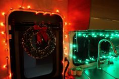 a bathroom decorated with christmas lights and a wreath