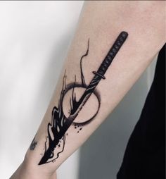 a person with a tattoo on their arm has a knife in the middle of it