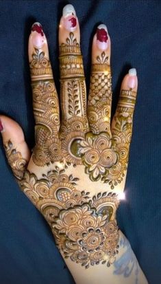 a woman's hand with hennap on it, showing the intricate design