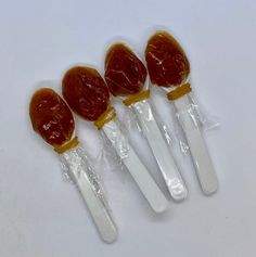 four jelly lollipops are wrapped in plastic