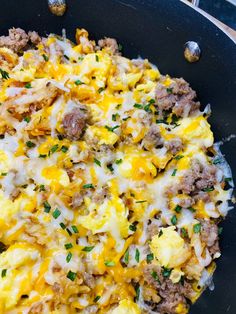 a skillet filled with eggs, sausage and cheese