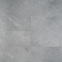 a grey marble tile floor with white and black lines on the bottom, in an irregular pattern