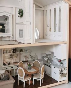 a doll house with all white furniture and accessories