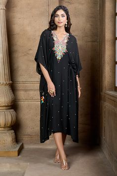 Black kaftan with contrast geometric embroidered yoke. Comes along with an inner slip dress
Components: 2
Pattern: Embroidery
Type Of Work: Geometric
Neckline: V Neck
Sleeve Type: Flared Sleeves
Fabric: Kaftan: Cotton Silk, Slip Dress: Tafetta
Color: Black
Other Details: 
Drawstring detailing with tassels
Occasion: Resort,Work - Aza Fashions Black Maxi Length Kaftan With Dabka, Black Floor-length Kaftan For Festive Occasions, Bollywood Style Black Kaftan With Dabka, Black Bollywood Kaftan With Dabka, Black Bollywood Kaftan For Party, Bollywood Black Kaftan For Party, Traditional Kaftan With Kimono Sleeves For Party, Black Kaftan With Dabka Work For Festive Occasions, Black Long Kaftan For Festive Occasions