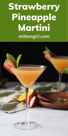 strawberry pineapple martini in coupe glasses with strawberries and mint garnish on the rim