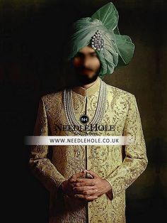 a man in a turban and gold outfit