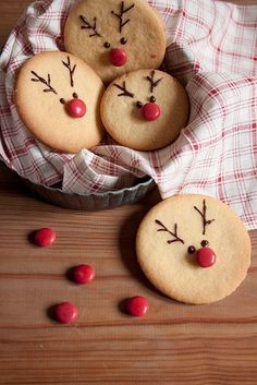 cookies decorated like reindeers with candy on the bottom and one cookie in the middle