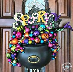 a pot full of halloween decorations sitting on top of a door