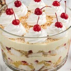 a trifle with whipped cream and cherries on top