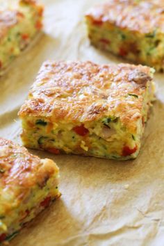 several pieces of quiche sitting on top of a piece of parchment paper