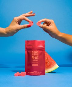 two hands reaching for a bag of good news next to a slice of watermelon