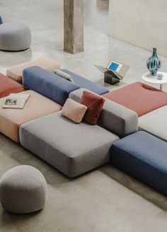 a multicolored sectional sofa with pillows on it