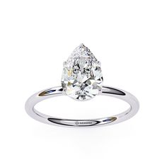 a pear shaped diamond ring on a white background