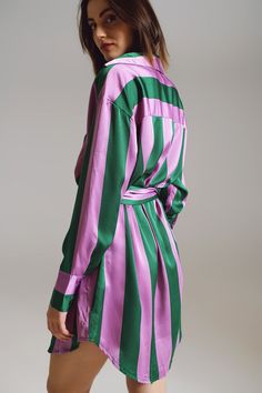 Introducing our "Lilac and Green Stripe Short Shirt Dress," a fusion of comfort and style that effortlessly enhances your daily wardrobe. Elevate your ensemble with the timeless allure of stripes showcased in this short shirt dress. The lilac and green striped design adds a pop of color to your look, while the satin fabric offers a touch of luxury and indulgence that's perfect for various occasions. The polo collar and long sleeves lend an element of refinement to the dress, while the relaxed fi Lilac And Green, Short Shirt Dress, Dress Collar, Short Shirt, Chic Shirts, Striped Shirt Dress, Lilac Dress, Trendy Fall, Perfect Wardrobe