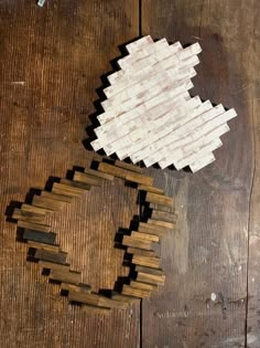 two pieces of wood sitting on top of a wooden table