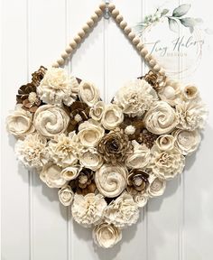 a heart made out of flowers hanging on a wall