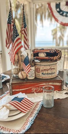 a table with american flags and other patriotic items on it, along with an old crate