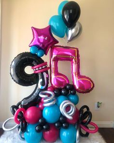 balloons and heliums are arranged in the shape of a tower for a 50th birthday party