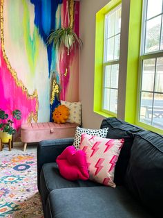 a living room filled with furniture and colorful walls