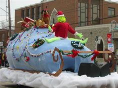 the float is decorated in blue and white with decorations on it's sides, including an elf riding a sleigh