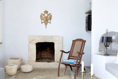 a living room filled with furniture and a fire place next to a wall mounted clock