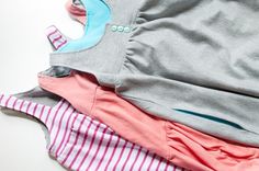 several different colored clothing laying on top of each other