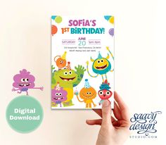 a hand holding up a birthday card with monsters on it and the words, sofia's 1st birthday