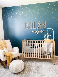 a baby's room painted in blue and gold with stars on the wall