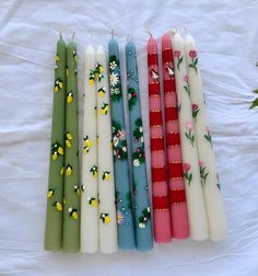 flower pattern Set of 2 taper candle. size 26*2.2 cm Model numbers are written under the candles Hand Painted Candle Sticks, Wax Painted Candles, Painted Candlesticks Diy, Candle Painting Ideas, Painted Candle Sticks, Candle Paintings, Painted Taper Candles, Paint Candles, Candle Decorating