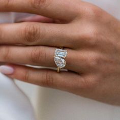 a woman's hand with a diamond ring on it