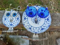 two blue and white plates sitting on top of a wooden table