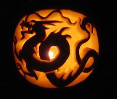 a carved pumpkin with a dragon on it