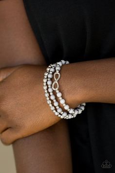 Neutral gray and shiny silver beads are threaded along stretchy bands, creating colorful layers around the wrist. A dainty silver infinity charm adorns one strand for a whimsical finish. Sold as one set of three bracelets. Silver Infinity Bracelets, Bracelet Set Silver, Infinity Charm, Grey Beads, Paparazzi Accessories, Stretchy Bracelets, Paparazzi Jewelry, Shiny Silver, Dainty Jewelry