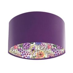 a purple lamp shade with flowers on it