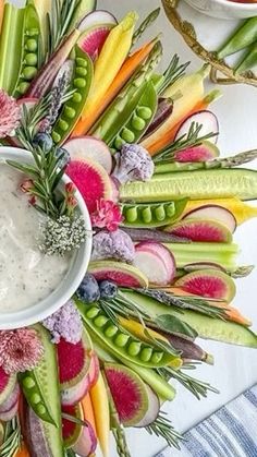 an arrangement of vegetables and dip in a bowl