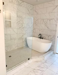 a bathroom with a tub, sink and shower stall