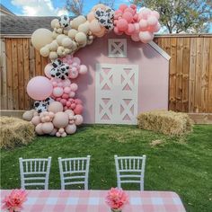 a pink barn decorated with balloons for a baby shower or birthday party in the backyard