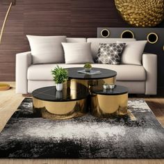 a living room with white couches, black tables and gold accents on the walls