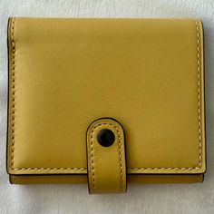 Excellent Used Condition. Glovetanned Leather Six Credit Card Slots Full-Length Bill Compartment Zip Coin Pocket Snap Closure 4 1/4" (L) X 3 1/4" (H) Yellow Leather Travel Wallets, Elegant Yellow Leather Wallet, Coach Rectangular Wallet With Snap Closure, Coach Leather Trifold Wallet With Card Slots, Coach Gold Leather Wallet, Yellow Leather Wallet For Everyday Use, Rectangular Leather Wallet With Snap Closure, Leather Wallet With Snap Closure, Snap Closure Rectangular Leather Wallet