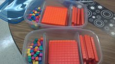 three plastic containers filled with different colored blocks