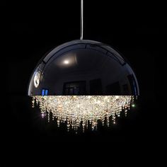 a chandelier hanging from the ceiling in a dark room with lights on it