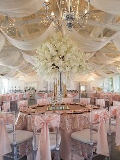 a banquet hall decorated in pink and white