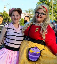 two women dressed in costumes standing next to each other