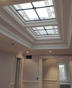 an empty room with two skylights above it