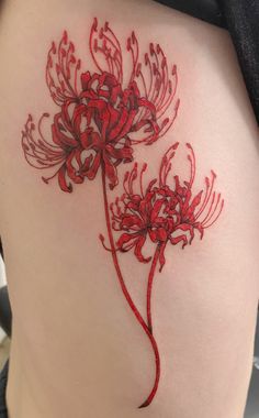 a woman's thigh with red flowers on it