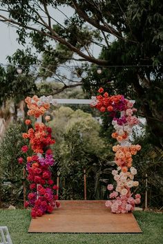 an outdoor ceremony setup with flowers on the aisle and chairs in the backgroud