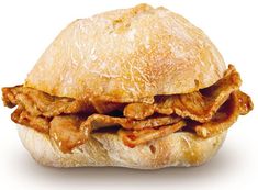 a sandwich with meat and sauce on it is shown in front of a white background