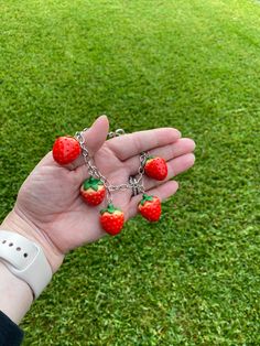 Adorable hand made strawberry charm bracelet. We have made limited quantities of the super cute strawberry bracelets for our summer collection . Matching earrings also available. The length can be customized on this bracelet. I can add or remove to make for the perfect size to fit your wrist . Measure the circumference of your wrist add .5 for the dangle and leave measurements in the notes to seller . Visit our shop for more fun , unique , whimsical jewelry. Now available in rose gold and 18 k g Sweet Strawberry Print Jewelry As Gift, Trendy Strawberry Print Jewelry As Gift, Trendy Strawberry Print Jewelry Gift, Cute Dangle Charm Bracelet, Cute Berry Colored Jewelry With Fruit Design, Cute Berry-colored Jewelry With Fruit Design, Cute Berry-colored Fruit Design Jewelry, Cute Handmade Charm Bracelet For Gifts, Cute Handmade Charm Bracelet As A Gift