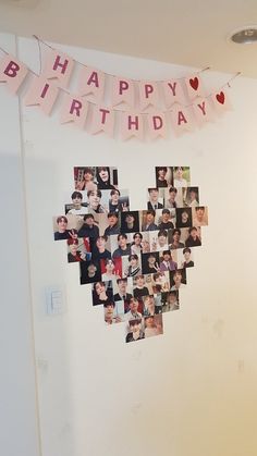 a heart - shaped photo collage is hanging on the wall in front of a happy birthday banner