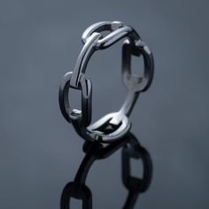 A minimal band ring in a chain link design with a super high reflective polish. This ring is 7mm wide and perfect for stacking.  Note- Follow the ring sizer guide and measure your finger circumference with a string or paper to get your most accurate size. We produce our pieces in 100% surgical grade 316L stainless steel. They are guaranteed to never rust, tarnish, discolour or turn your skin green. They are waterproof, sweat proof and hypoallergenic. All of our products come with a lifetime warr Chain Link Ring, Link Ring, Mens Rings Fashion, Mens Rings, Linking Rings, Matching Rings, Ring Sizer, Men's Rings, Dainty Ring